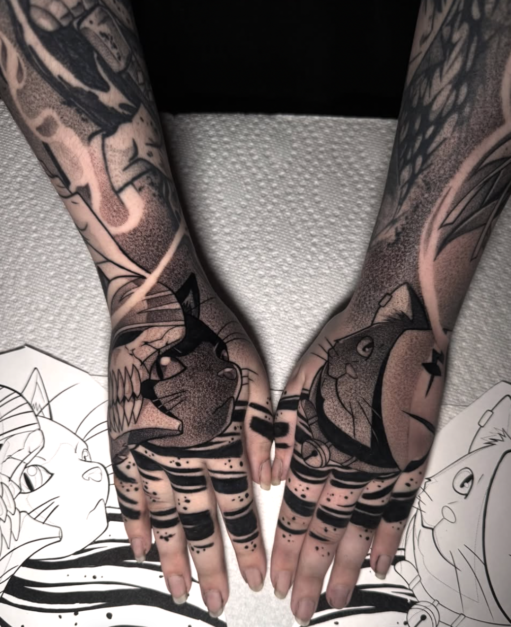 Matching black and grey anime cat hand tattoos with dotwork shading